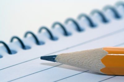 image of a pencil on top of a notepad