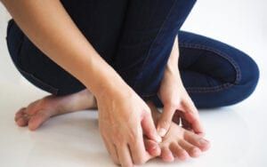 Woman holding aching foot